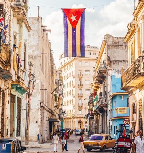 Havana, Cuba - December 22, 2015: A Cuban flag with holes waves over a street in Central Havana.
